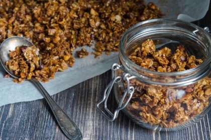 Open glass jar with homemade granola
